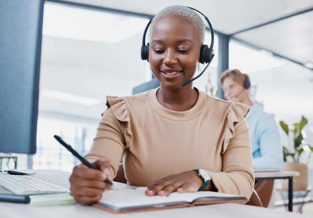 CRM, notebook and planning telemarketing consultant woman writing strategy, solution or idea with s